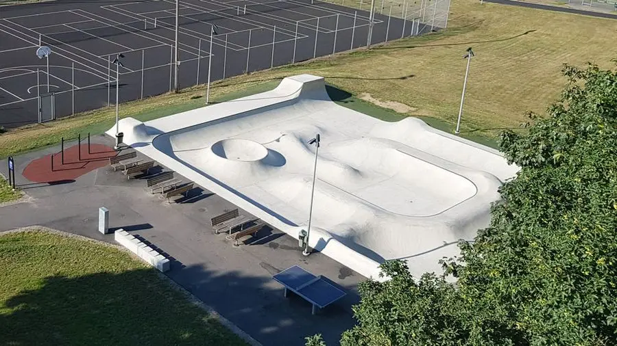 En rektangulär skateboardbana i grå betong sedd ovanifrån